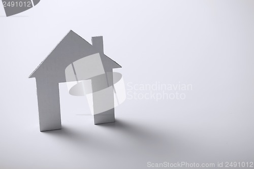 Image of white paper house over white background