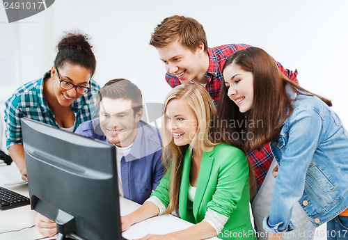 Image of students with computer studying at school