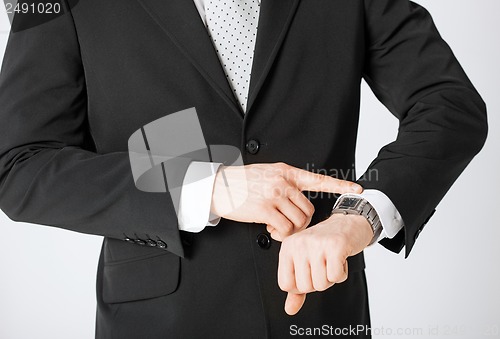 Image of man looking at wristwatch