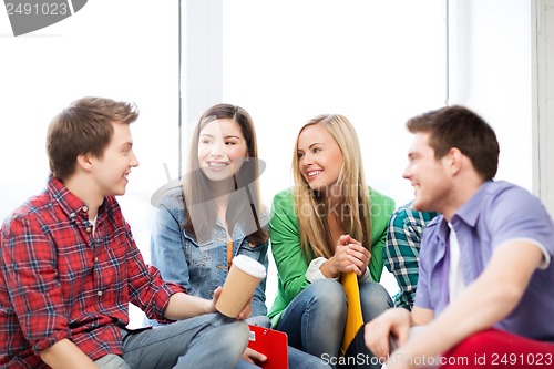 Image of students communicating and laughing at school