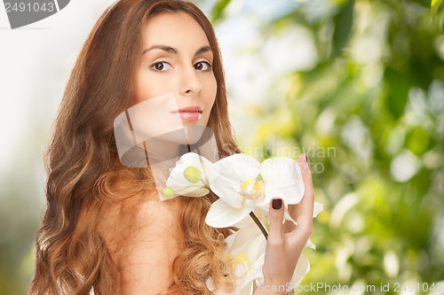 Image of beautiful woman with orchid flower