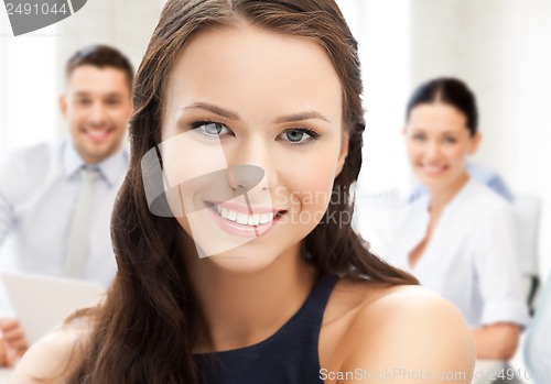 Image of attractive young businesswoman in office