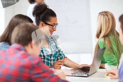 Image of african student girl with laptop at school