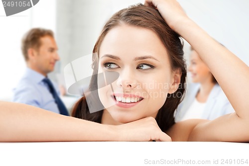 Image of attractive young businesswoman in office