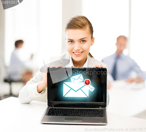 Image of businesswoman holding laptop with email sign