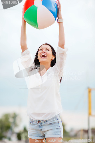 Image of girl playing ball on the beach