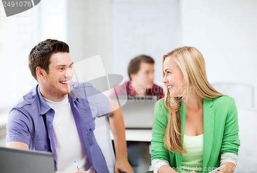 Image of smiling students looking at each other at school