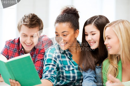 Image of students reading book at school