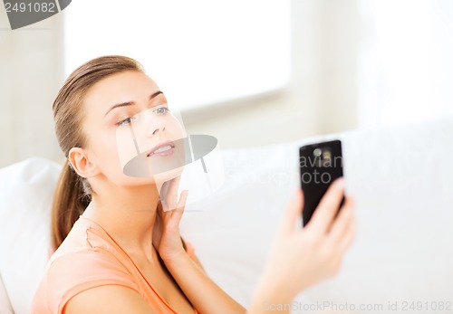 Image of woman making self portrait with smartphone