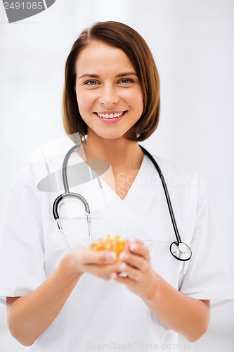 Image of doctor holding bowl of capsules
