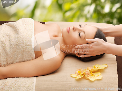 Image of woman in spa getting facial massage