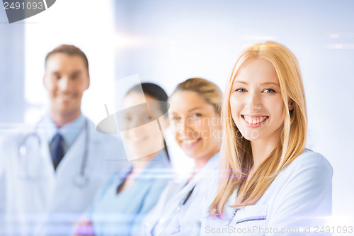 Image of female doctor in front of medical group