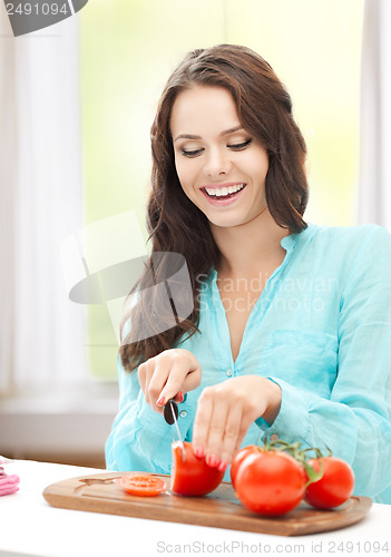 Image of woman in the kitchen cutting tomatoes