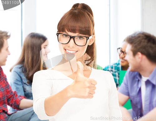 Image of student showing thumbs up at school