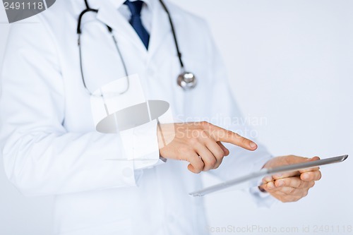 Image of male doctor holding tablet pc