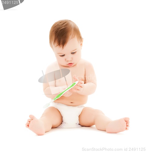 Image of curious baby brushing teeth