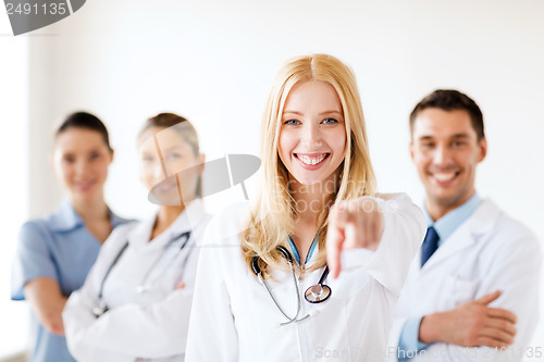 Image of female doctor in front of medical group