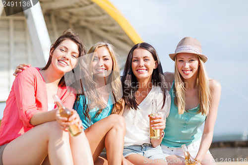 Image of girls with drinks on the beach