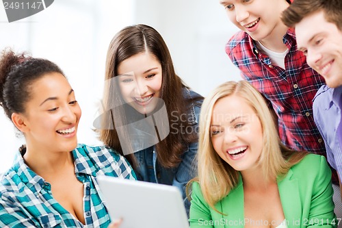 Image of students looking at tablet pc in lecture at school