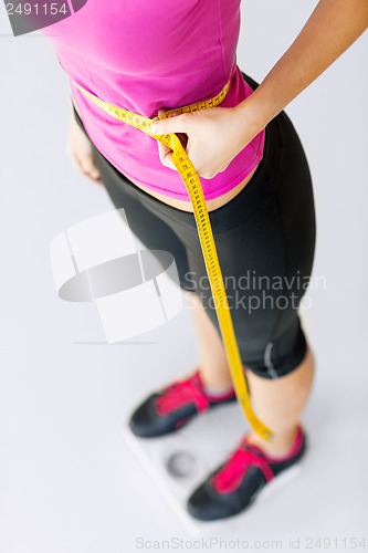 Image of trained belly with measuring tape