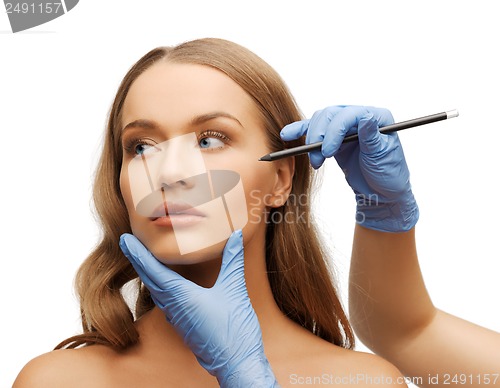 Image of woman face and beautician hands with pencil