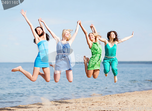 Image of girls jumping on the beach