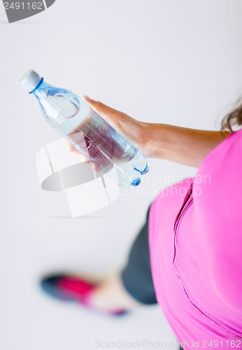 Image of sporty woman with bottle of water