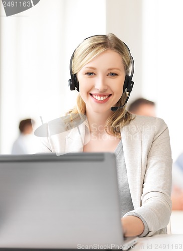 Image of helpline operator with headphones in call centre