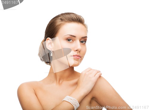 Image of beautiful woman with pearl earrings and bracelet