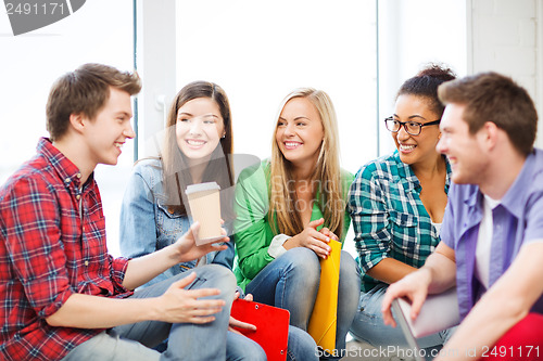 Image of students communicating and laughing at school