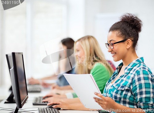 Image of african student with computer studying at school