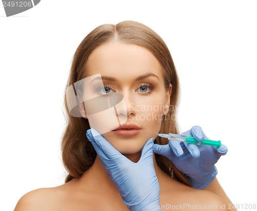 Image of woman face and beautician hands with syringe