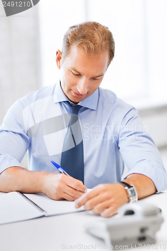 Image of handsome businessman working in the office