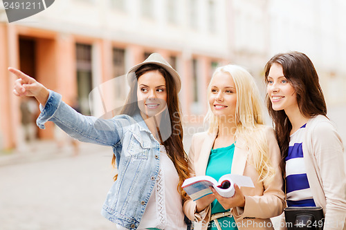 Image of beautiful girls looking for direction in the city