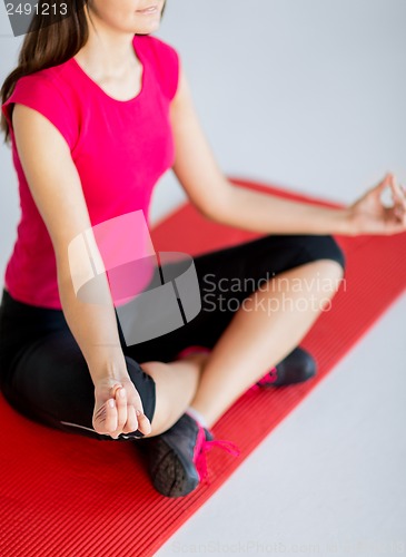 Image of girl sitting in lotus position and meditating