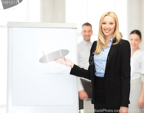 Image of businesswoman with flipchart in office