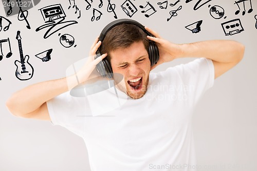 Image of man with headphones listening loud music