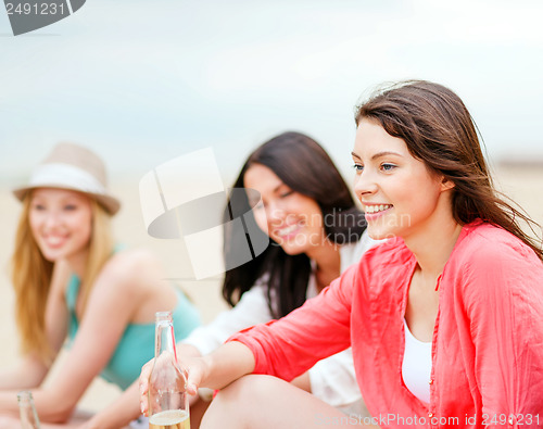 Image of girls with drinks on the beach