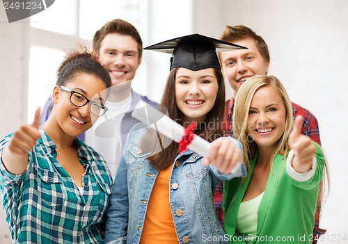 Image of student girl in graduation cap with diploma