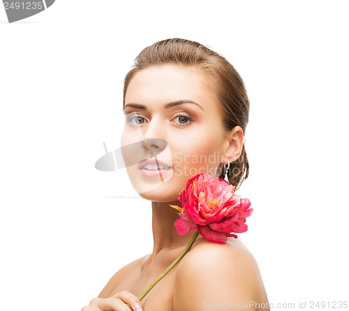 Image of woman with diamond earrings and flower