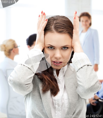 Image of stressed businesswoman in office