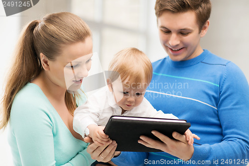 Image of parents and adorable baby with tablet pc