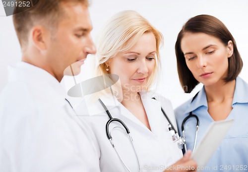 Image of doctors looking at tablet pc