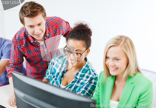 Image of students with computer studying at school