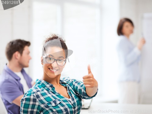 Image of african student girl showing thumbs up