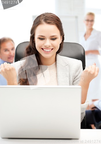 Image of businesswoman with computer in office