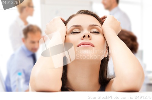 Image of stressed businesswoman in office