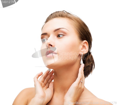 Image of woman wearing shiny diamond earrings