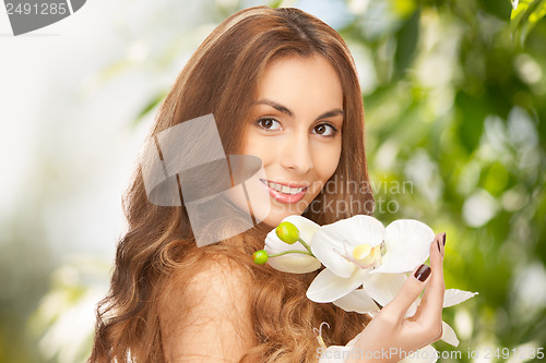 Image of beautiful woman with orchid flower