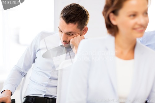 Image of tired businessmen sleeping on conference